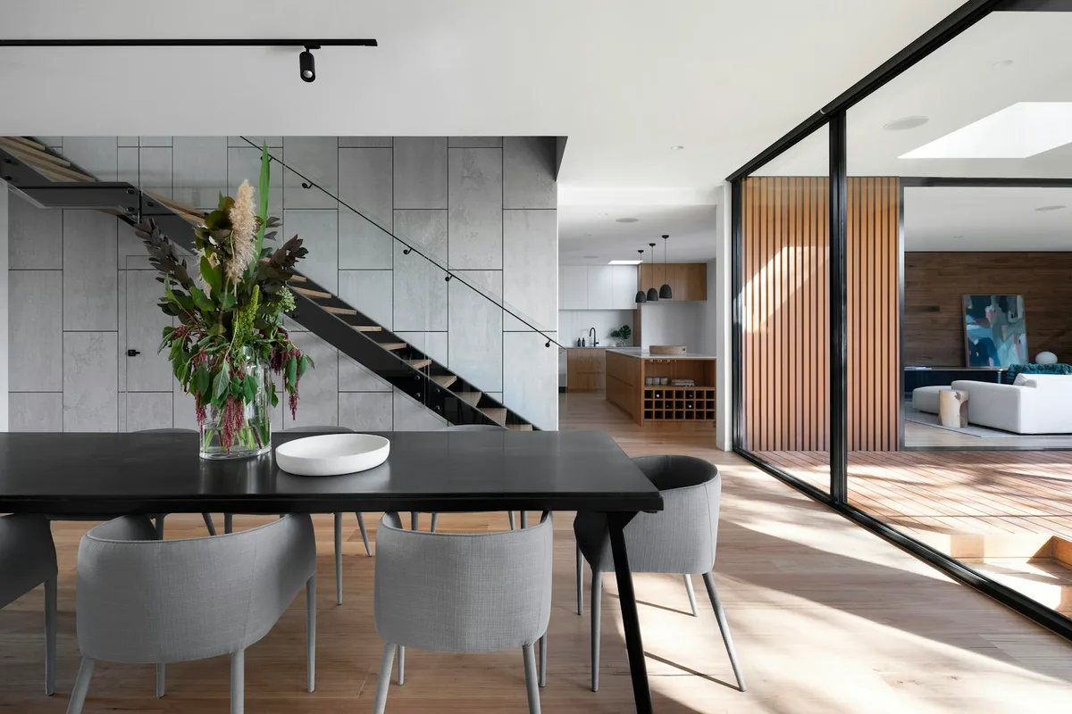 Thoughtful architecture and natural light connecting a dining room and kitchen